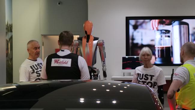 The pair poured orange goo over a Tesla Optimus Robot at a London Westfield on Wednesday as part of a stunt to get people to join their protests at parliament Square in April. Photographer: Jamie Lowe