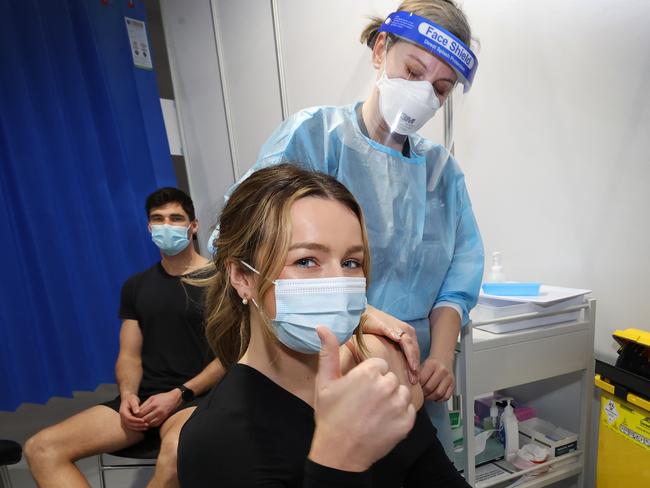 Claire Edler and Jacob Mahony get the AstraZeneca vaccine together in Melbourne earlier this month. Picture: David Caird