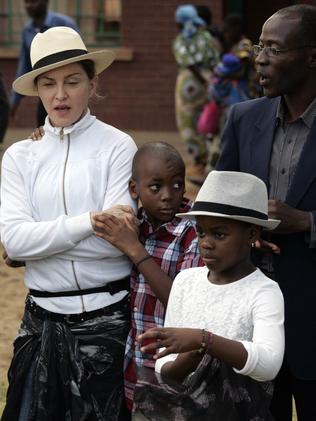 Madonna with her adopted kids David and Mercy in 2013. Picture: AFP/Amos Gumulira