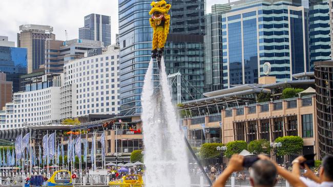 Lion Dancers practice on jet-packs before a performance at Darling Harbour during Lunar New Year’s celebrations in Sydney. Businesses in Western Harbour say the the precinct must be strengthened as an attraction for people to visit, work and live. Picture: Jeremy Piper