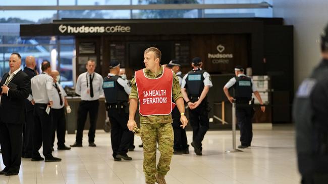 Police and SA Health officials wait for the arrival of the mercy flight at Adelaide Airport. Picture: Mike Burton/AAP