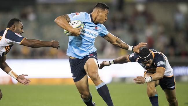 Israel Folau of the Warathas fends off a tackle during the Round 7 Super Rugby match between the Brumbies and the NSW Waratahs at GIO Stadium in Canberra, Saturday, March 31, 2018. (AAP Image/Rohan Thomson) NO ARCHIVING, EDITORIAL USE ONLY