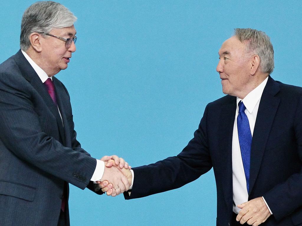 Nursultan Nazarbayev shakes hands with Kassym-Jomart Tokayev. Picture: Stanislav Filippov/AFP