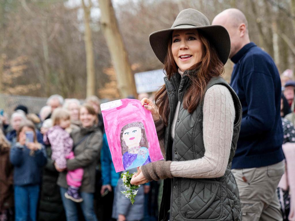 The monarch chatted with fans and was even given a drawing of what appears to be a portrait of her. Picture: AFP