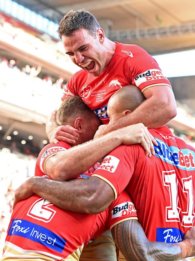 BRISBANE, AUSTRALIA - MARCH 05: Jamayne Isaako of the Dolphins is congratulated by team mates after scoring a try during the round one NRL match between the Dolphins and Sydney Roosters at Suncorp Stadium on March 05, 2023 in Brisbane, Australia. (Photo by Bradley Kanaris/Getty Images)