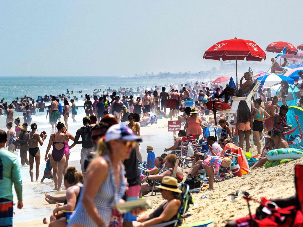 Thousands of beachgoers find refuge under umbrellas and in the water at Rehoboth Beach, Delaware, on July 28. Picture: Jim Watson/AFP