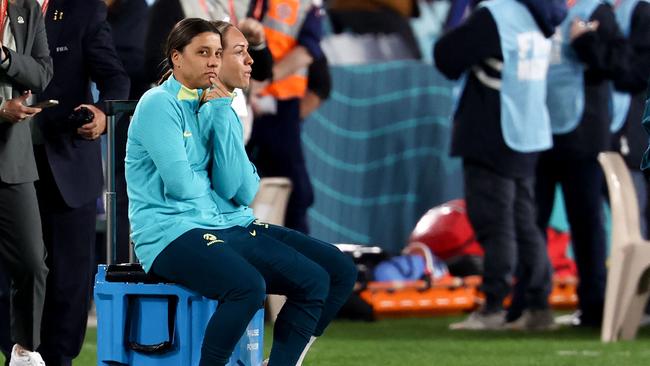 Injured Australian star Sam Kerr (L) sits on the sideline. Picture: AFP