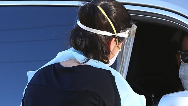 PERTH, AUSTRALIA - FEBRUARY 01: Members of the public attend the Rivervale drive thru Covid-19 testing clinic on February 01, 2021 in Perth, Australia. Lockdown restrictions are now in place across the Perth, Peel and South West regions of Western Australia following the discovery of a positive community COVID-19 case in a worker from a quarantine hotel facility.  As of 6pm on Sunday, people Perth, Peel and the South West are subject to stay at home orders, and will only be allowed to leave their homes to shop for essentials, for medical or health needs, exercise within their neighbourhood or travel to work if they cannot work from home. Face masks are now mandatory outdoors, with all restrictions to remain in place until 6pm on February 5. (Photo by Paul Kane/Getty Images)