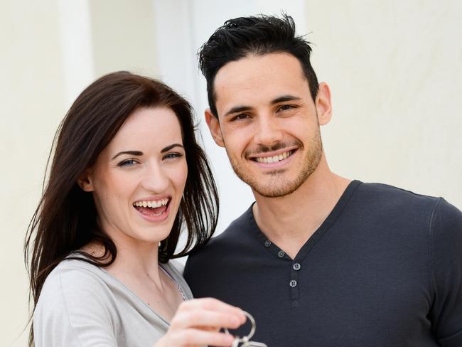 happy young couple welcome in their new house showing the door house keys. Young couple, first homebuyers.Picture: THINKSTOCK