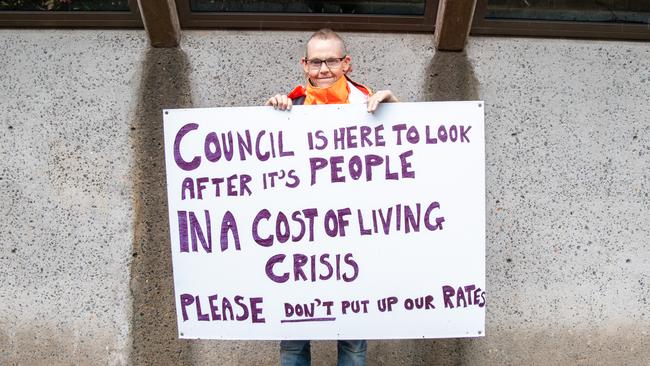 A protester outside the meeting. Picture: Thomas Lisson