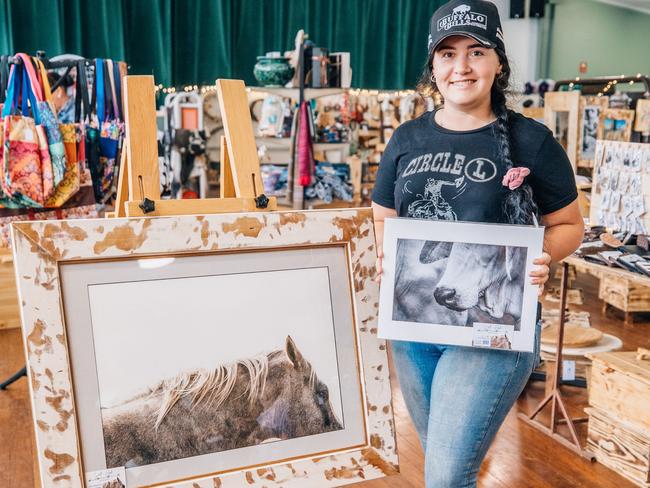 Photographer Kelly Beresford from Wolf and Hide Photography with some of her prints.