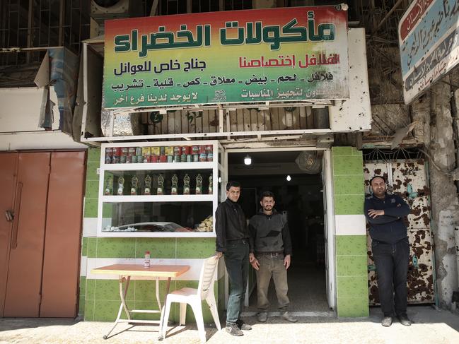 Falafel shop owner Omar Luqman, 35, right with Maan Hussein, left, and Omar Luqman. Picture: Ella Pellegrini