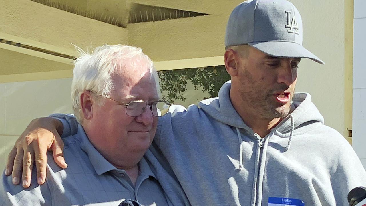 Jason Coffman, right, talks to the media about his son, Cody Coffman, who died in the shooting. Picture: AP