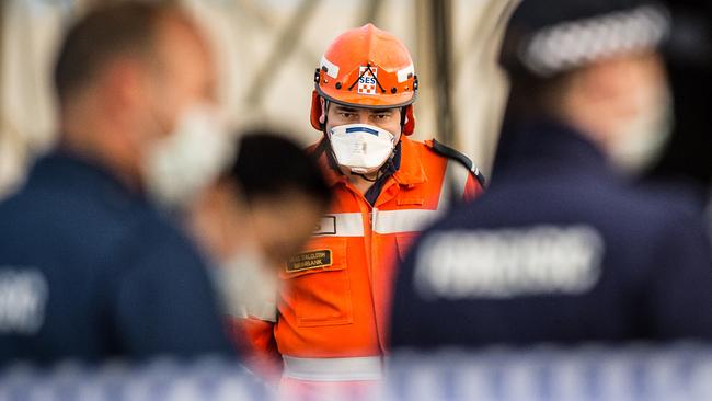 Forensic police and SES officers at the Caltex service station in Keilba where Aaron Burnett was wounded. He later died in hospital.