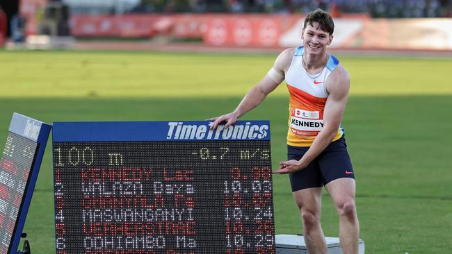 Lachlan Kennedy poses next to his time after breaking the 10-second barrier. Picture: AFP