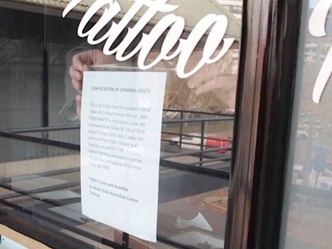 A sign pinned to the door of the Lakeside Tattoo Parlour stating the business had been seized under confiscation of criminal assets legislation.