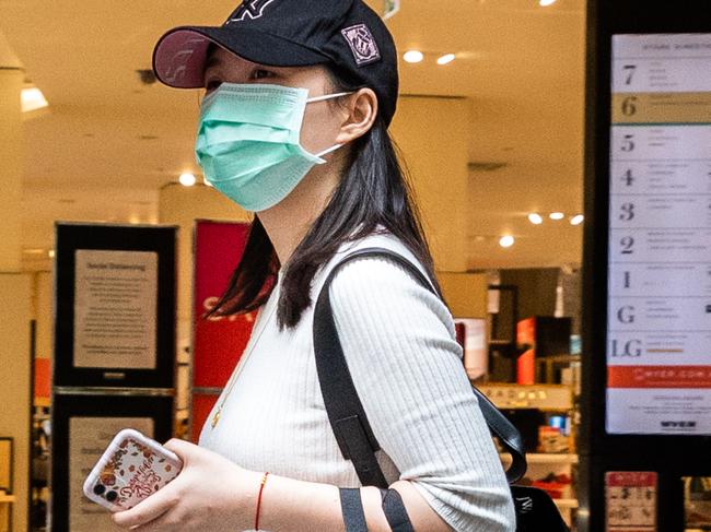 MELBOURNE, AUSTRALIA - MARCH 29: A woman wearing a face mask walks past the Myer Bourke Street department store on March 29, 2020 in Melbourne, Australia. The Australian department store announced it would be temporarily shutting down all Australian stores due to COVID-19 from Sunday until at least 27 April 2020. Around 10,000 staff will be stood down without pay during that time. Myer's closure comes as many other well known stores shut down as the coronavirus (COVID-19) outbreak and new social distancing measures take a toll on the retail industry. (Photo by Asanka Ratnayake/Getty Images)