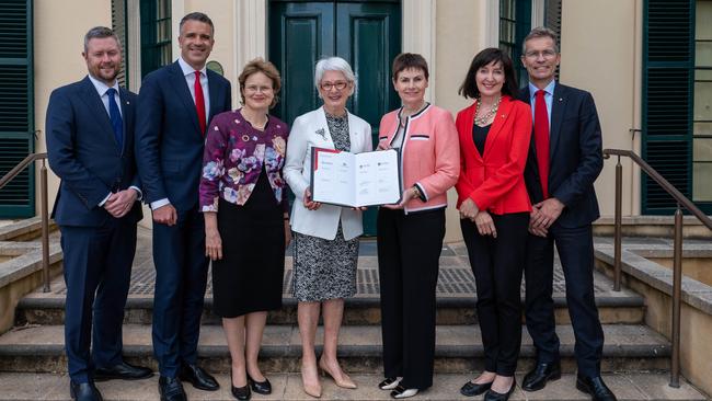 Outside Government House after signing merger documents last December are (L-R) University of SA vice-chancellor David Lloyd, Premier Peter Malinauskas, Governor Frances Adamson, University of Adelaide chancellor Catherine Branson, UniSA chancellor Pauline Carr, Deputy Premier Susan Close and University of Adelaide vice-chancellor Professor Peter Hoj. Picture: Naomi Jellicoe