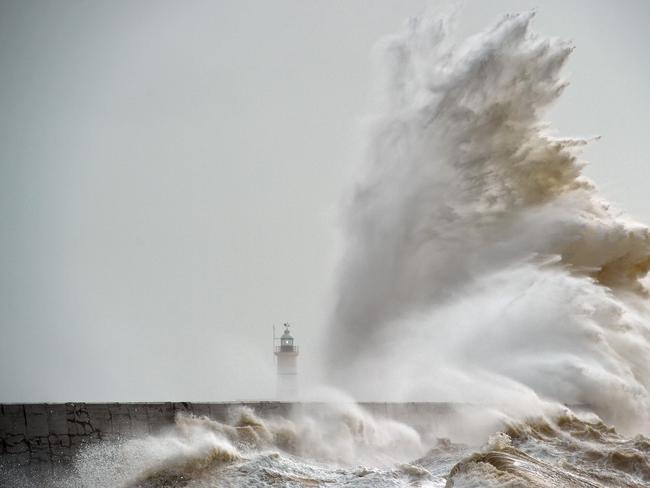 Waves crash over Newhaven Lighthouse on the south coast of England on February 8, 2016, as the latest storm hits the country. Heavy winds buffeted Europe’s northwestern flank on Monday, forcing road closures and disrupting rail and ferry services in southern England and prompting high wave alerts in France’s Brittany region. Picture: AFP PHOTO / GLYN KIRK