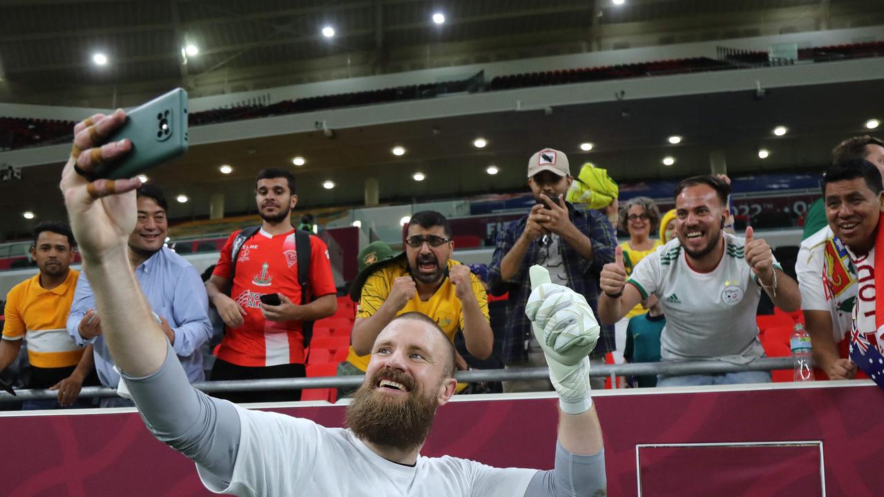 Australia's goalkeeper Andrew Redmayne poses for a selfie with fans after his shootout heroics.