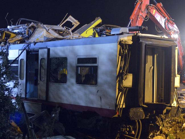 Rescuers work on the scene of a train accident after two commuter trains collided head-on near the town of Andria, in the southern region of Puglia, killing several people, Tuesday, July 12, 2016. (AP Photo/Gaetano Lo Porto)