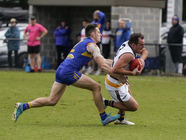 Luke Bull sticks a tackle playing at Noble Park. Picture: Valeriu Campan