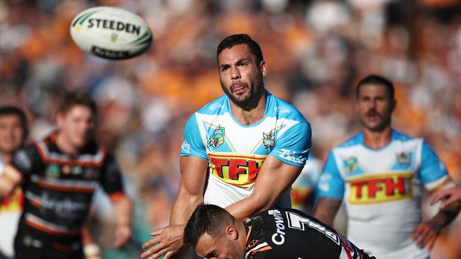 Ryan James of the Titans offloads the ball in a tackle during the round 16 NRL match between the Wests Tigers and the Gold Coast Titans. Photo: Getty Images