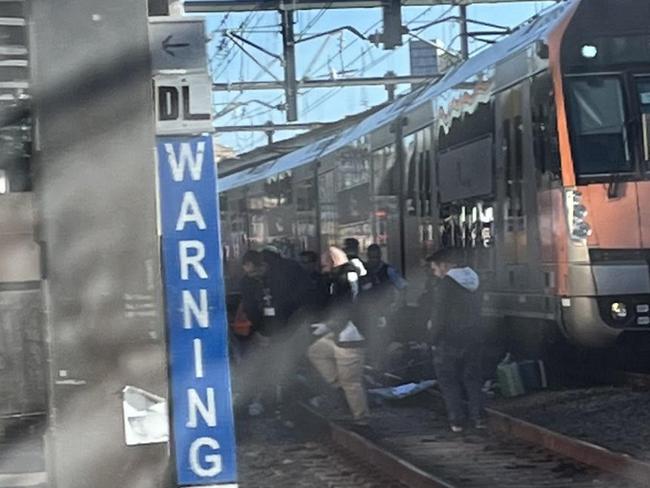 Police and paramedics were seen on the tracks during the incident. Photo: Twitter/Josh Newy