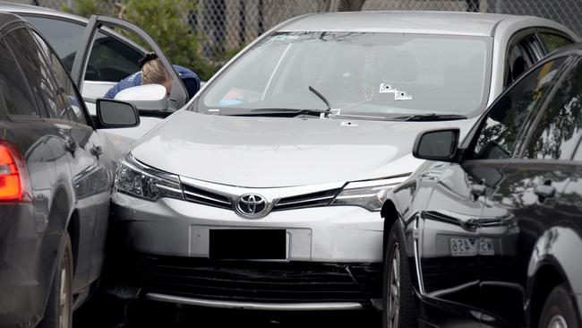 Bulletholes are visible in the windshield of the silver Toyota Corolla. Picture: Andrew Henshaw