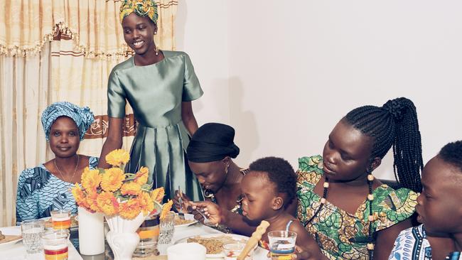 Adut Akech, pictured standing, is kicking goals. Her latest was landing on the front cover of Vogue Australia. Picture: Charles Dennington for Vogue Australia December 2018