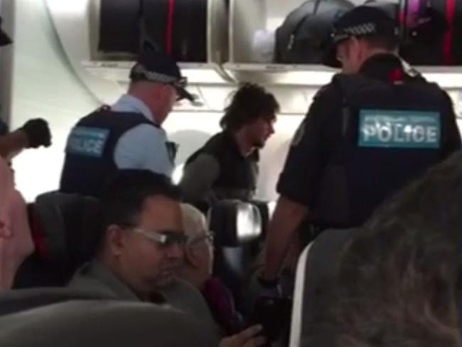 The 25-year-old man allegedly tried to escape through the plane’s door mid-flight. Picture: Seven News