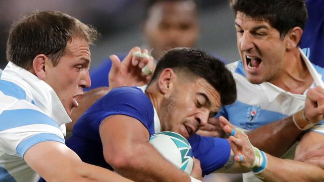 France's Romain Ntamack is tackled by Argentinian defenders during the Rugby World Cup Pool C game at Tokyo Stadium between France and Argentina in Tokyo, Japan, Saturday, Sept. 21, 2019. (AP Photo/Christophe Ena)