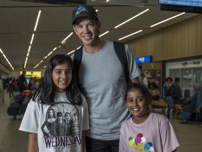 Myra Aggarwal, 10, and Anvi Parekh, eight, with Tim Paine at Hobart Airport on Friday. Picture: Caroline Tan