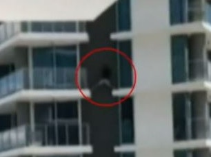 A man has been filmed jumping between balconies on a high rise residential building on the Gold Coast.