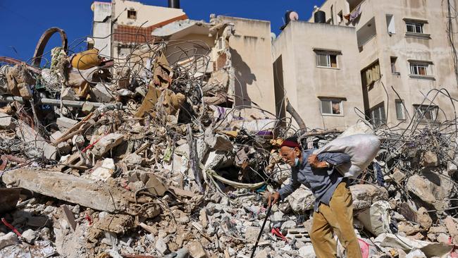 A Palestinian man walks past a building destroyed by Israeli bombardment in Gaza City. Picture: AFP