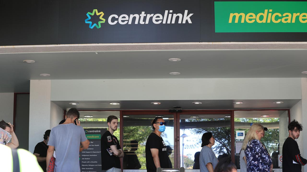 Lines of people wait at Southport Centrelink. Picture: Adam Head.