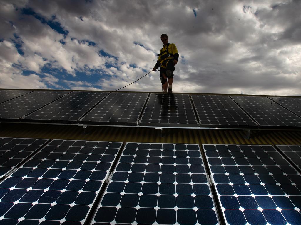 A territory worker installing Solar panels as Jacana energy lowers the solar feed in tariff to 8c, further disincentivising the up take of home solar in the NT.Picture GLENN CAMPBELL