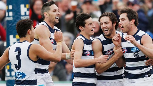 Geelong teammates flock to Dan Menzel after he goals against Richmond. Picture: Getty Images