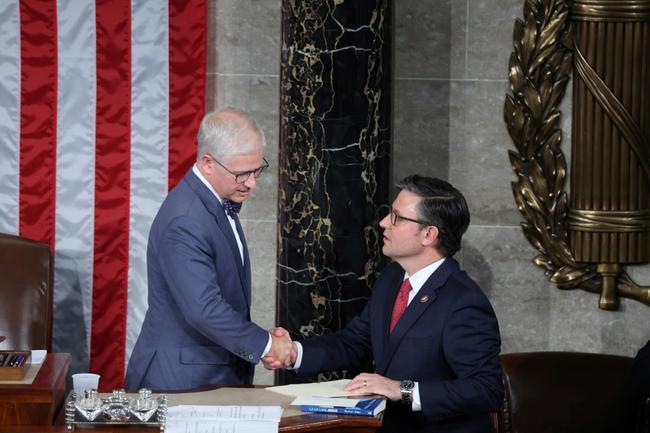 Mike Johnson (R), Republican of Louisiana, shakes hands with House Speaker Pro Tempore Patrick McHenry, shortly before Johnson is elected as speaker of the US House of Representatives