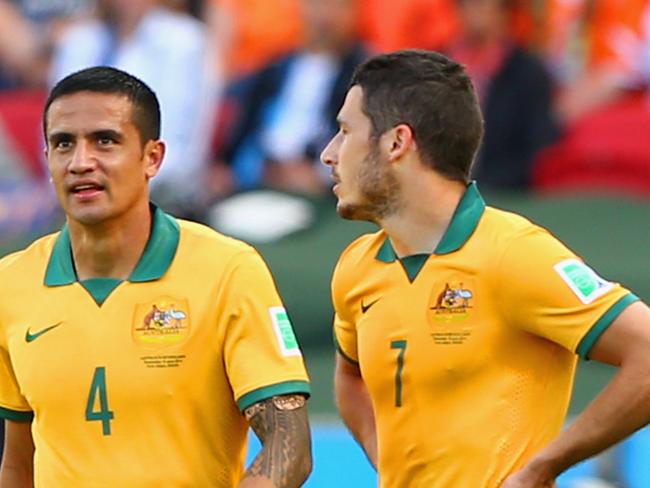 PORTO ALEGRE, BRAZIL - JUNE 18: Tim Cahill of Australia reacts after receiving a yellow card as teammates Mathew Leckie looks on during the 2014 FIFA World Cup Brazil Group B match between Australia and Netherlands at Estadio Beira-Rio on June 18, 2014 in Porto Alegre, Brazil. (Photo by Cameron Spencer/Getty Images)