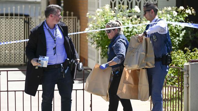 Police Major Crime officers remove bags of evidence. Picture: Mark Brake