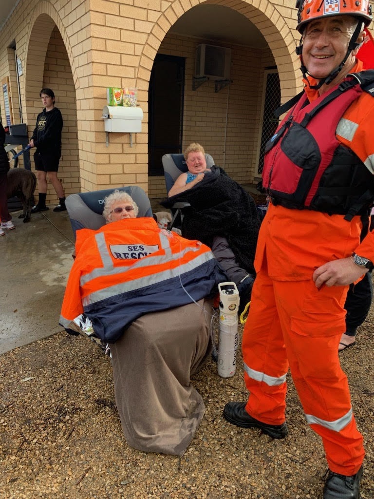 Helen Schulz with her friend Kay Chandler after being rescued after floods at Middleton Caravan Park.