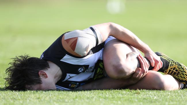 Action from TSL game between Clarence v Glenorchy from Richmond Oval. Glenorchy's Aiden Grace lays on the ground after inuring his leg in a contest. Picture: Zak Simmonds