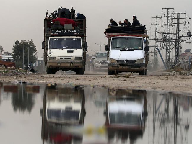 Displaced Palestinians drive on Salah al-Din road in al-Mughraqa in the central Gaza Strip, on February 13, 2025, as people move towards the northern parts of Gaza during a current ceasefire deal in the war between Israel and Hamas. (Photo by Eyad BABA / AFP)