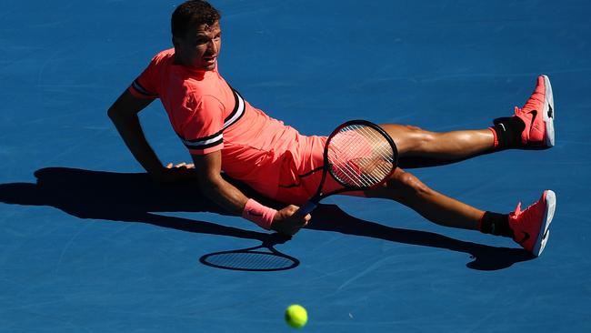 Grigor Dimitrov hits the deck during his crushing round-one win. Picture: Getty