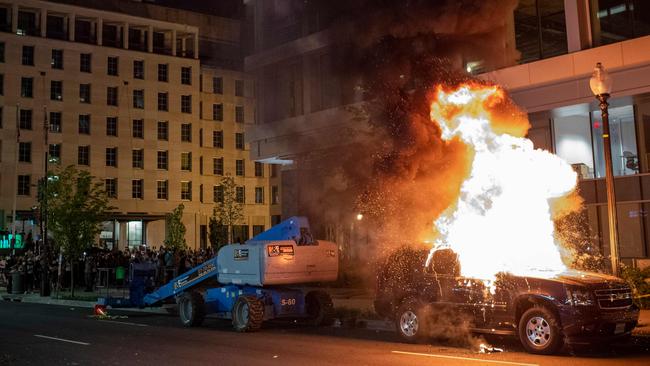 A car set on fire by protesters one block away the White House. Picture: AFP