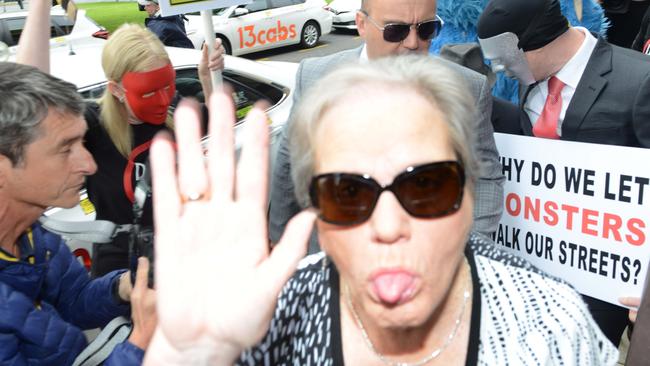 Margaret Deboo, the wife of child sex predator Vivian Deboo, sticks out her tongue as she walks past a demonstration to support her husband’s victims in November 2018. Picture: Brenton Edwards/AAP