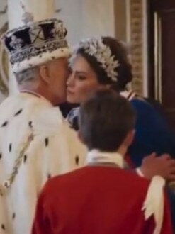 Kate kisses her father-in-law on the cheek …