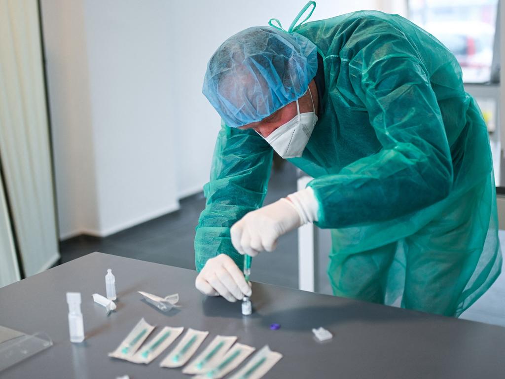 Doctor Klaus Renckhoff prepares syringes the coronavirus vaccine at his medical office in Hagen, western Germany. Picture: AFP