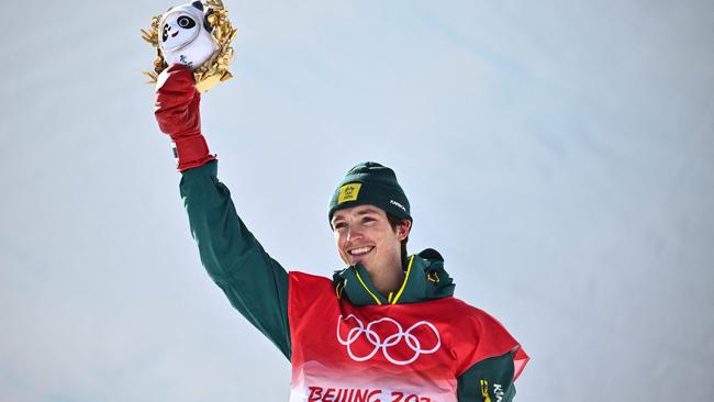 Australia’s Scotty James gets a panda mascot and some flowers after winning silver in the men’s snowboard half pipe final in Beijing. Picture: Marco Bertorello.